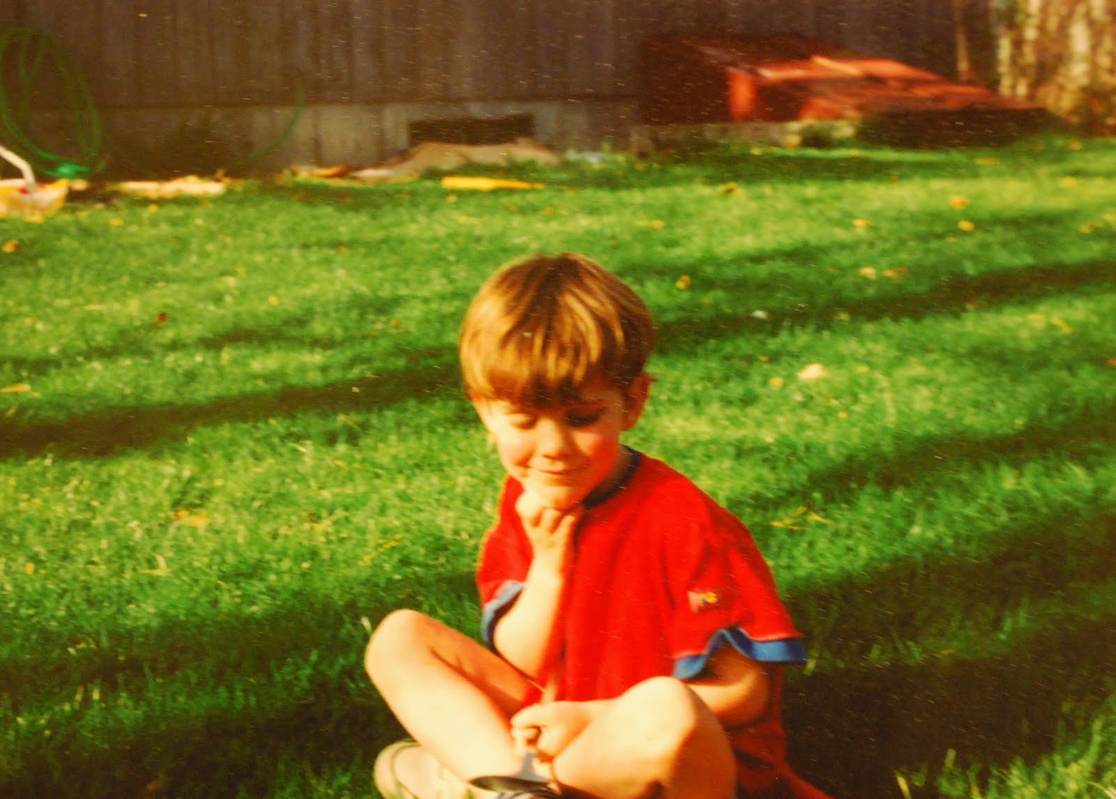 a picture of a young red-headed boy smiling with his eyes closed.
